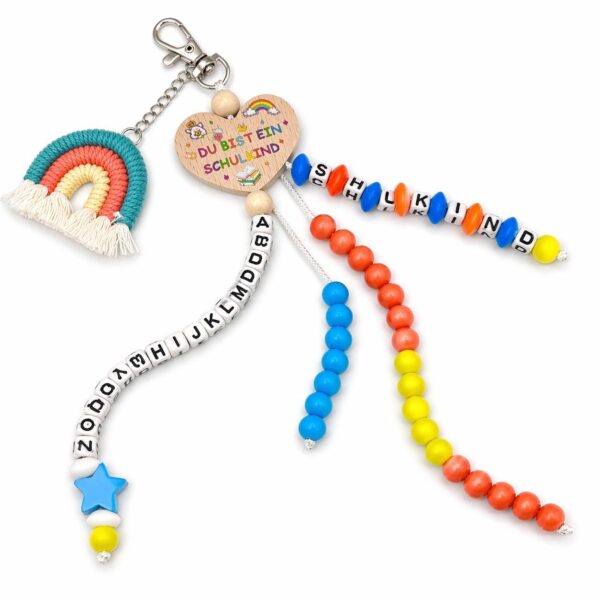 76562085df6a1204e5e85fde1b6a7d76.jpg Einschulungs-Anhänger für Jungen mit Geschenkbox – Schulkind Schlüsselanhänger mit Holzherz, Regenbogen, ABC-Perlen und SCHULKIND Schriftzug